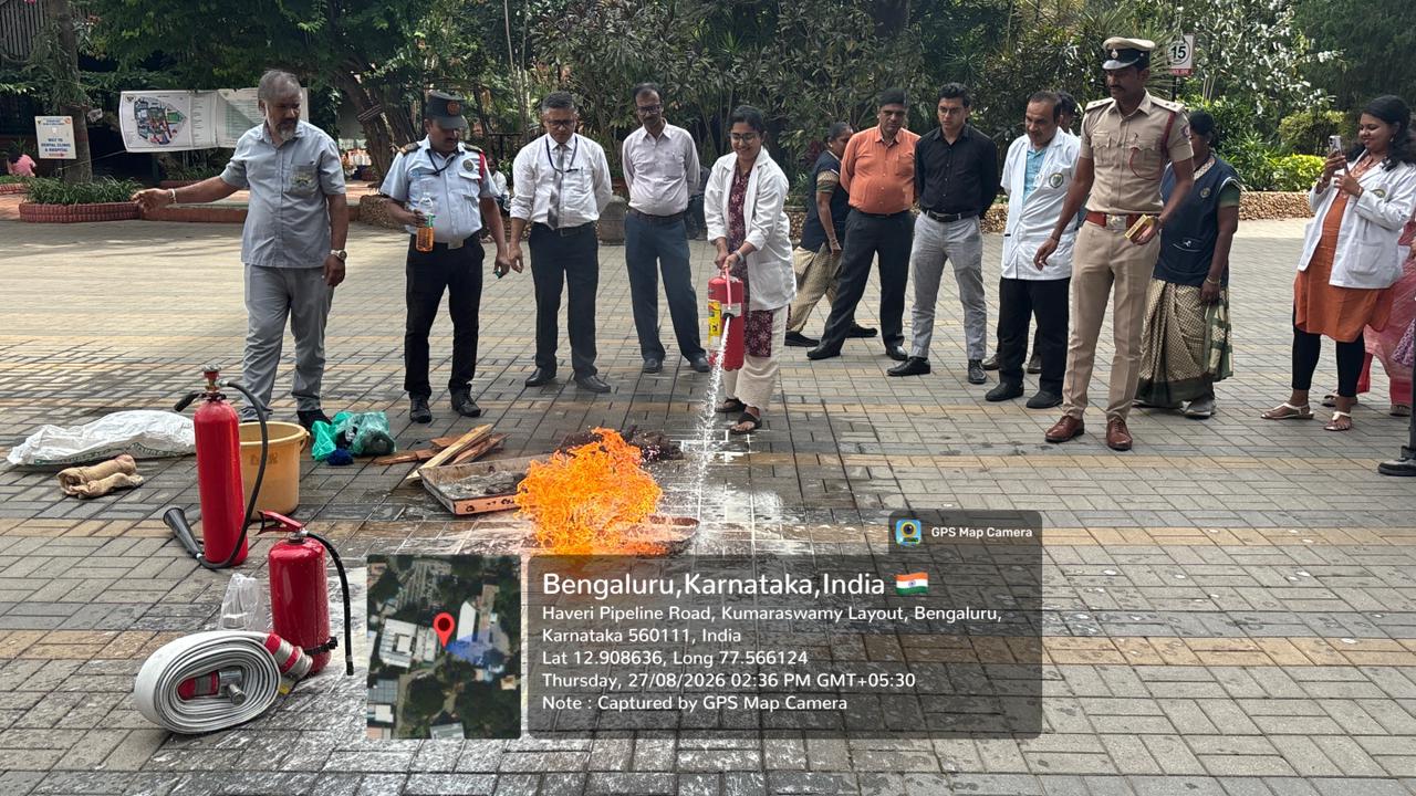 Staff member practicing fire extinguishing using portable extinguisher